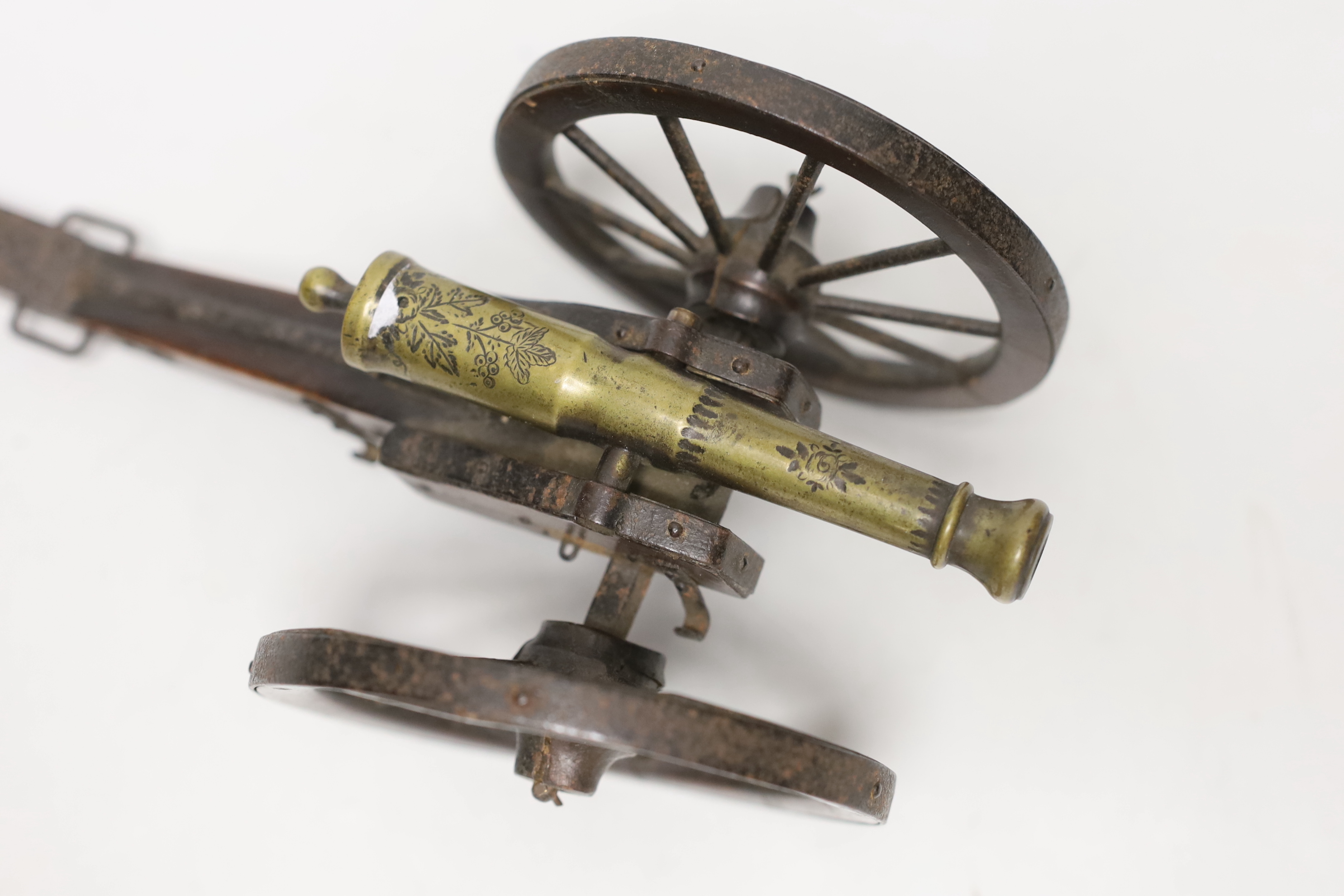 A 19th century model of an artillery gun, on wood carriage